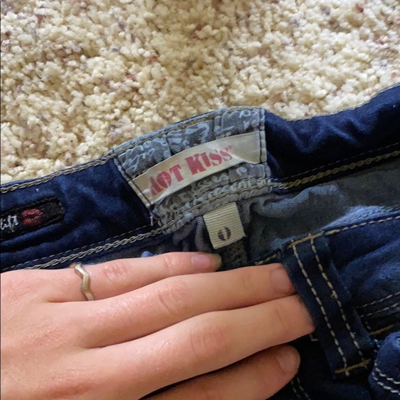 This is a pair of stretchy distressed denim jeans. - Picture 2 of 2